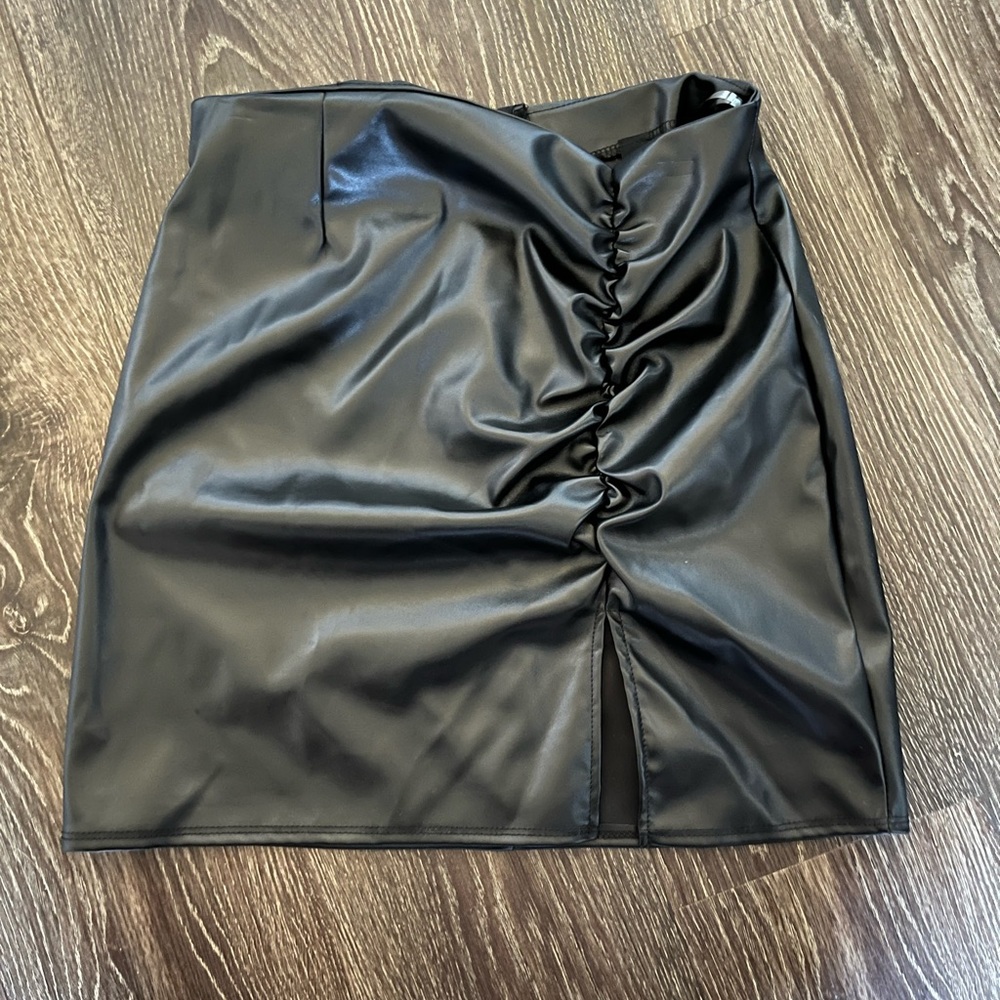 Black leather skirt. Slit leg mini skirt.